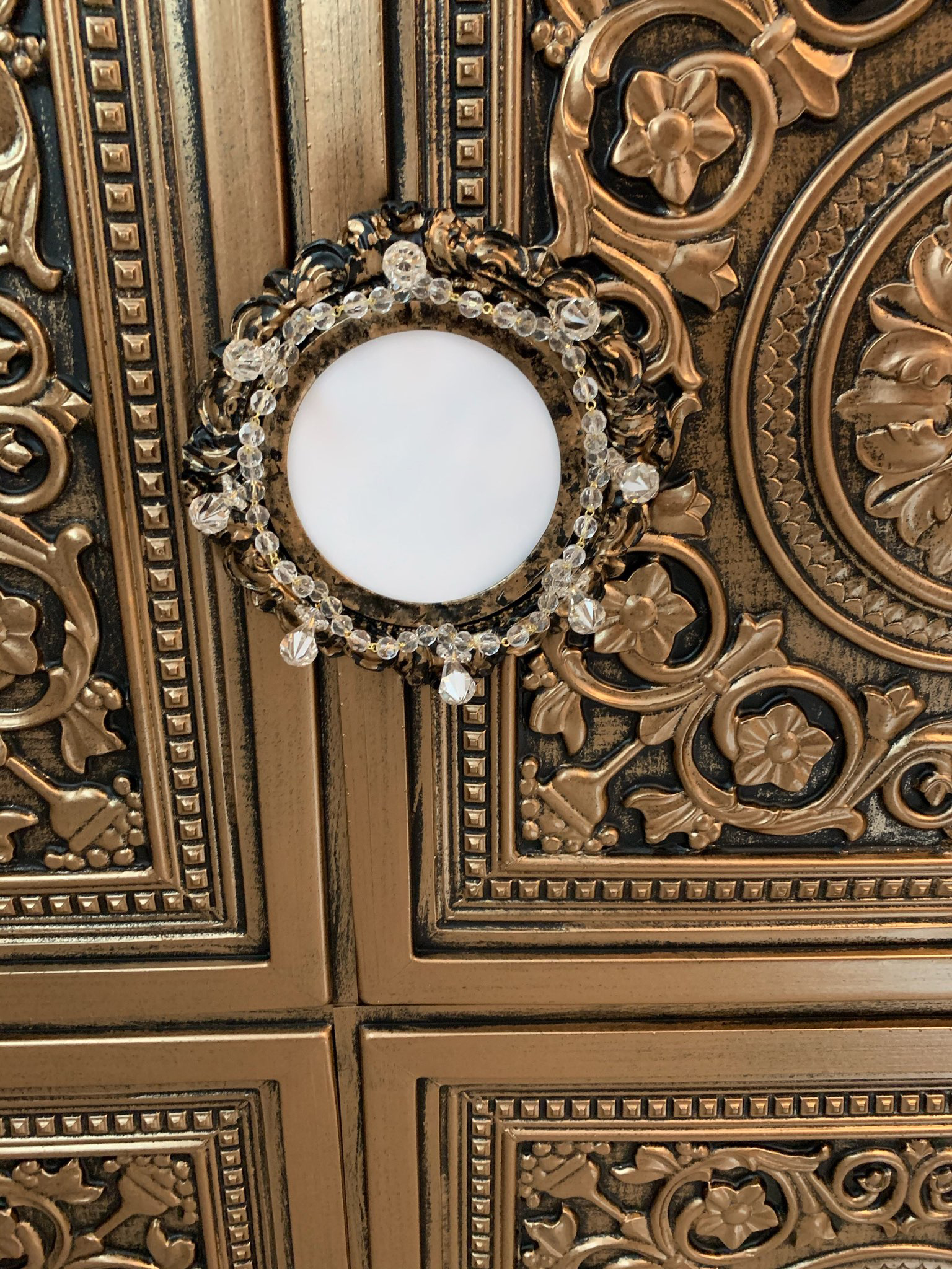 Recessed light trim embellished with crystals on Metal Ceiling in Antique Brass Finish