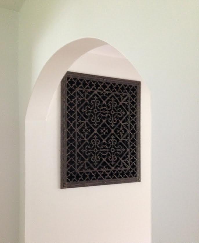 decorative vent cover on the wall in rubbed bronze finish