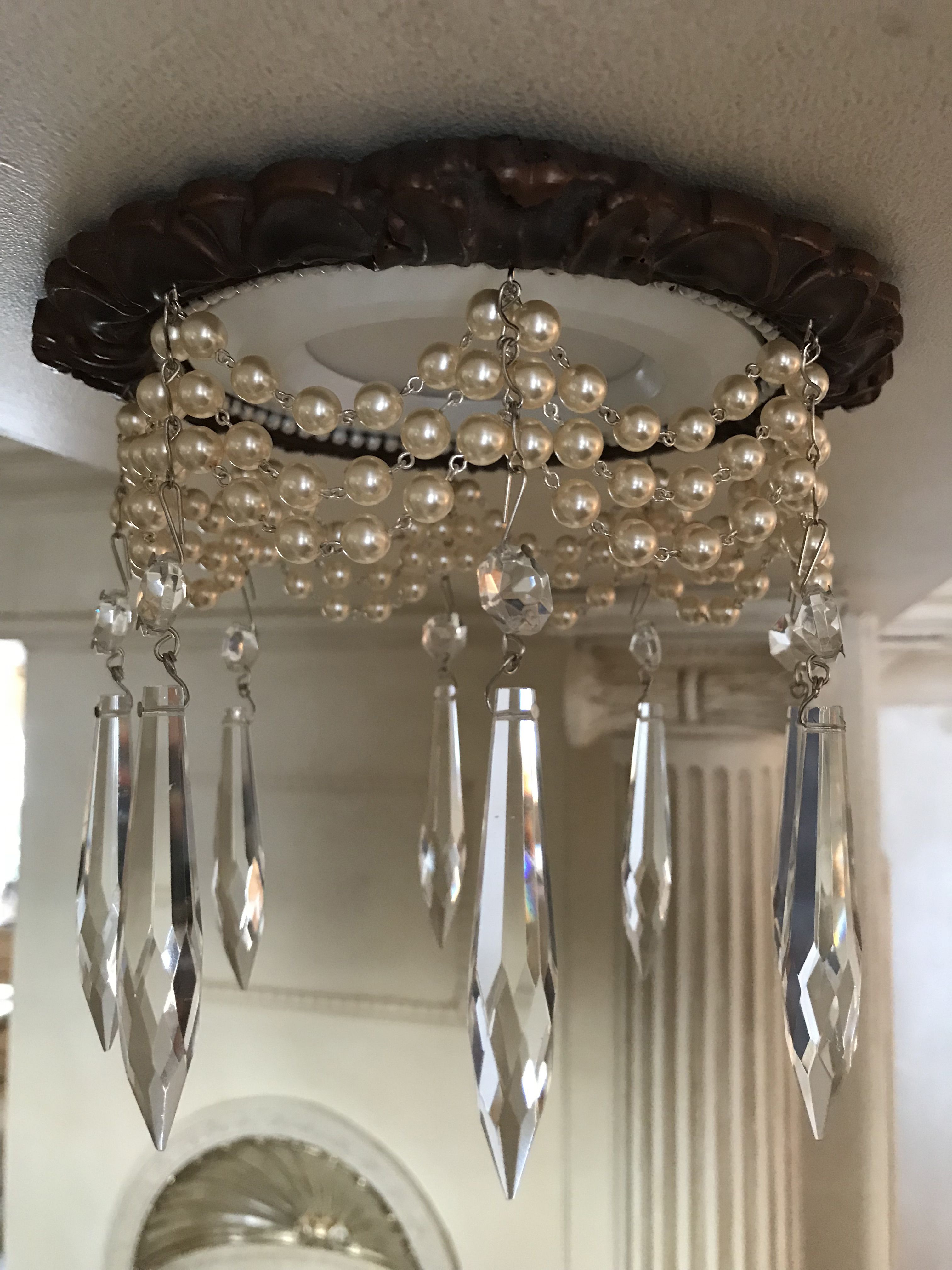 decorative recessed light trim embellished with triple strand of pearls and 3" U-drop crystals
