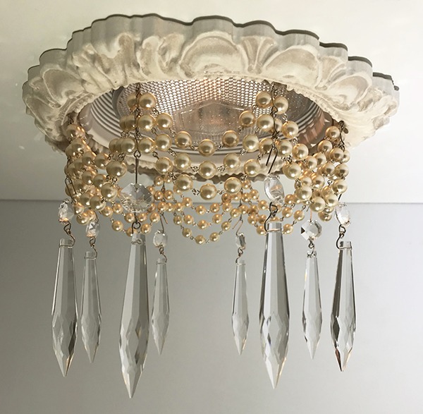 Recessed Light covers feature decorative recessed light trim embellished with cream pearl chains and 3" clear crystal U-drop crystals.