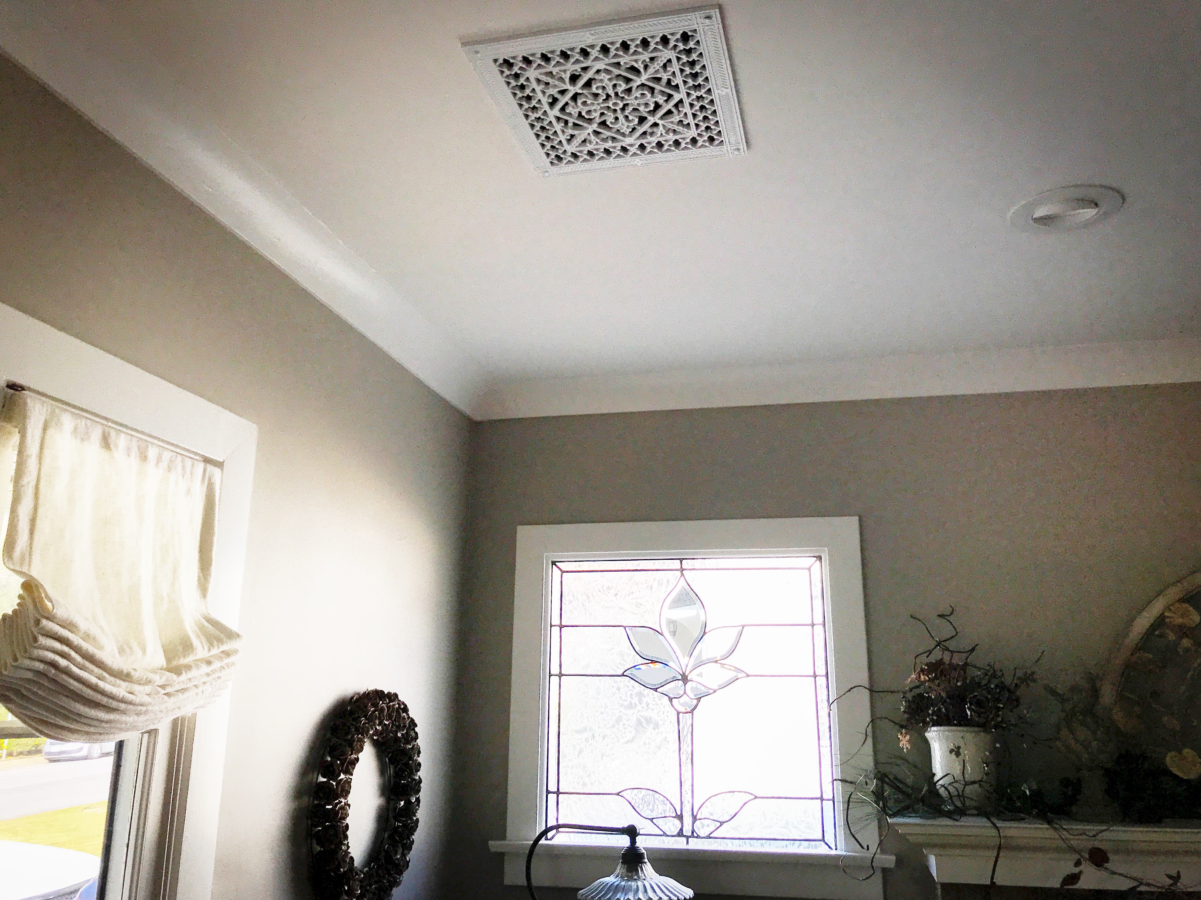 Arts and Crafts style decorative vent cover ceiling installation.