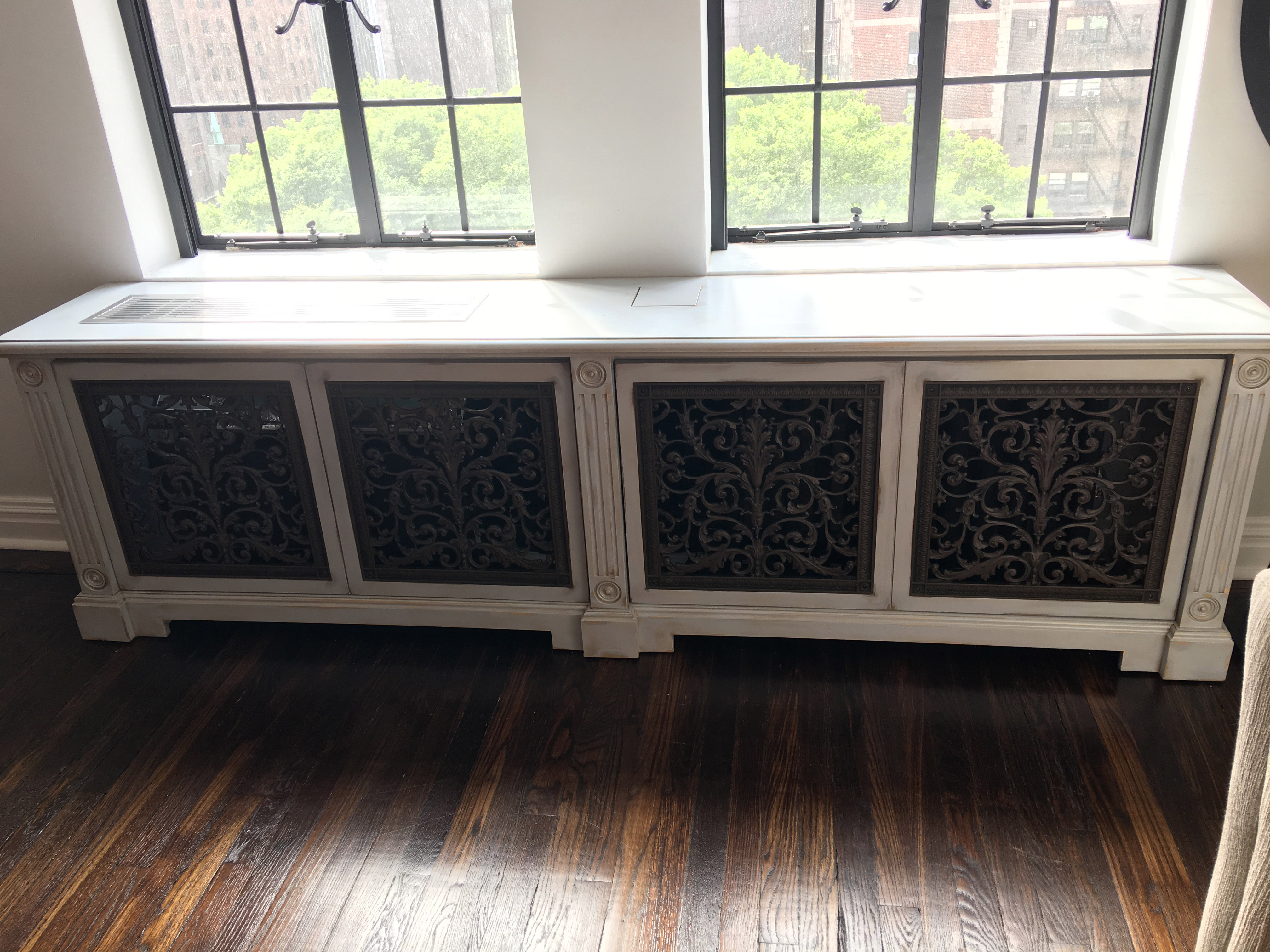 After picture with Louis XIV decorative grilles to cover the air conditioner and radiator.