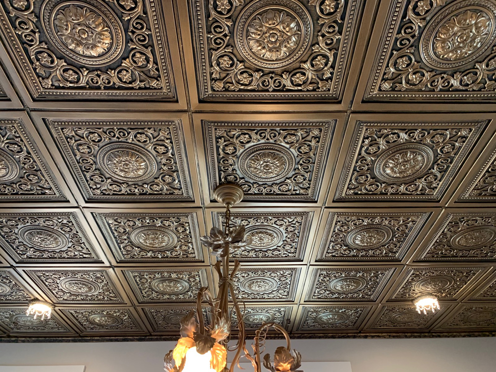 Metal ceiling with Beaux-Arts Classic Products decorative recessed light trims with crystals.