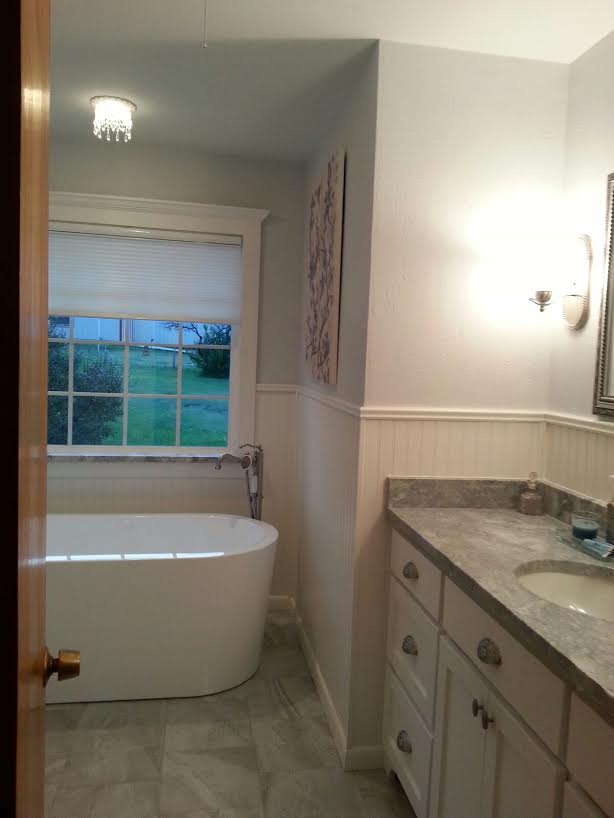 Recessed chandelier over a soaking tub.
