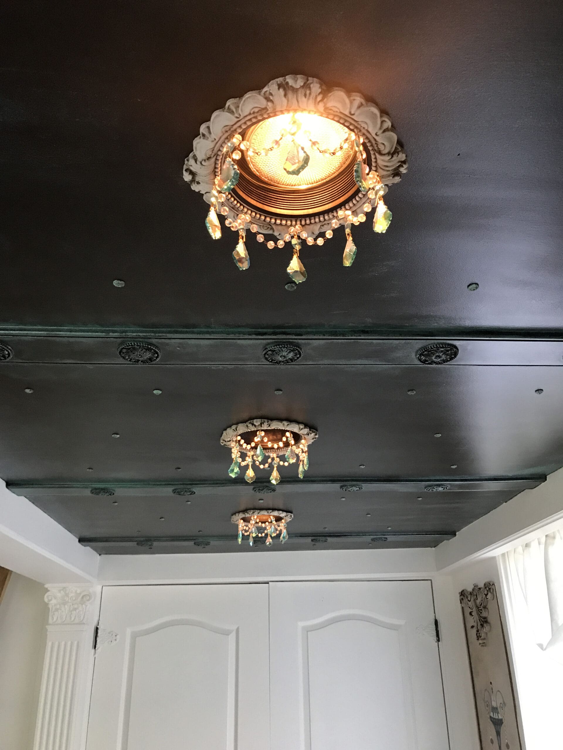 Recessed chandeliers add to the impact of a decorative ceiling.